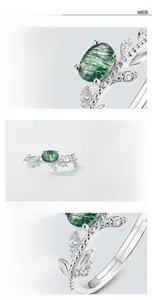 Macro detail of moss agate ring with vine leaf S925 silver band and zircon accents