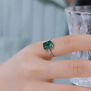 Irregular green moss agate ring in S925 silver with small side diamonds on a hand