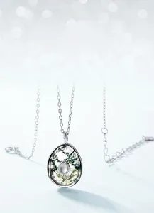 Macro shot of silver S925 moss agate necklace pendant with natural green patterns