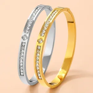 Titanium steel bangles in gold and silver with clover relief and sparkling crystals