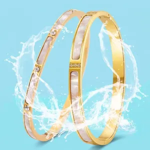 Waterproof gold titanium steel bangle with white shell inlay and zircon accents