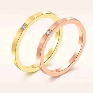 Dual thin stackable titanium steel rings in gold and rose gold with zircon stones