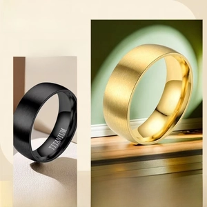 Macro detail of black and gold titanium steel rings with brushed finish and engraving