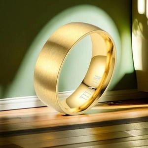 Macro shot of matte brushed gold titanium ring with engraved interior steel seal