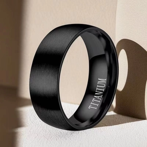 Detail shot of black titanium ring featuring a brushed finish and interior engraving