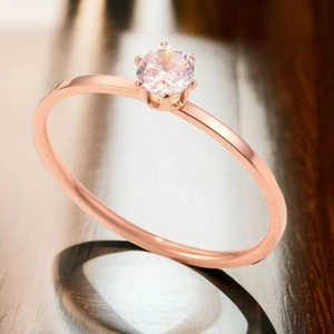 Détail de la bague en or rose avec un zircon solitaire serti dans six griffes classiques