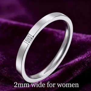 Detail of 2mm thin titanium steel ring with sparkling zircon on purple velvet