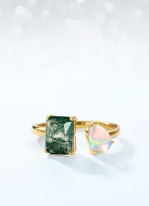 Close-up of gold-plated silver ring with moss agate and opal stones