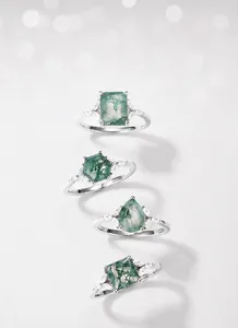Detailed view of four moss agate rings in pear, hex, and square cuts with S925 silver bands