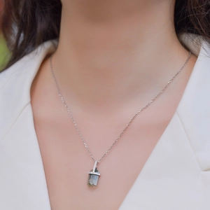 Natural moss agate hexagonal prism pendant with S925 silver chain worn by a model