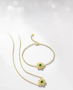 Detailed macro view of daisy necklace set with emerald gem and white zircon petals