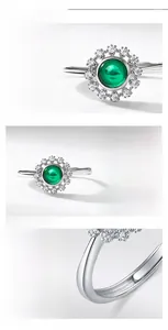 Detail view of oval lab emerald ring in S925 silver with high-carbon diamond halo