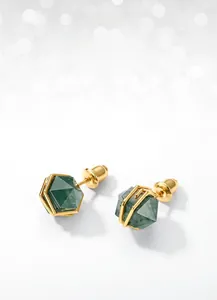 Macro detail of gothic moss agate earrings with hexagonal cut and gold-plated wire wrapping