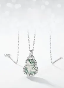 Macro shot of S925 silver gourd necklace with natural moss agate and sparkling zircons