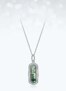 Close-up of green moss agate pendant in rectangular shape with vintage silver frame