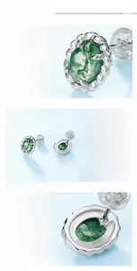 Close-up of S925 silver oval moss agate stud earring with intricate claw setting