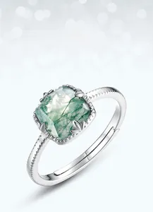 Macro detail of S925 silver ring featuring cushion-cut moss agate and fine leaf prongs