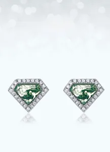 Detailed view of pentagon moss agate studs with silver setting and sparkling zircon border