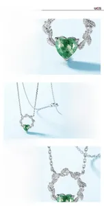 Macro shot of S925 silver heart necklace featuring green moss agate with leaf details