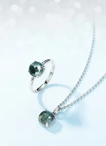 Macro shot of S925 sterling silver stamp and natural moss agate stone jewelry set