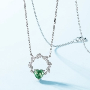 S925 silver necklace with moss agate heart and crystal wreath pendant on light blue backdrop
