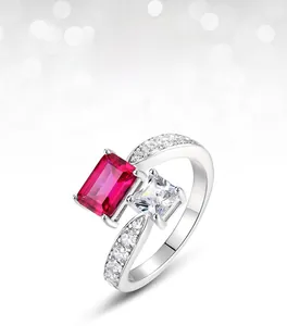 Macro shot of silver ring featuring dual emerald-cut red ruby and square white zircon stones