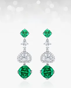 Macro shot of S925 silver earrings with square green garnet and heart-shaped inlay detail