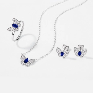 Close-up of S925 silver butterfly jewelry set with blue gemstone and pavé diamonds