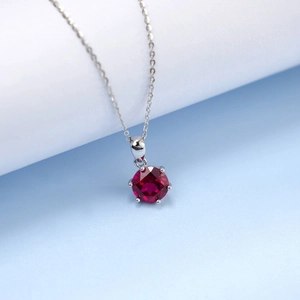 Macro shot of red gemstone necklace with six-prong S925 silver setting and fire brilliance