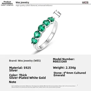 Macro detail of S925 silver ring featuring five prong-set round lab-grown emeralds
