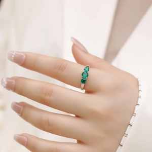 Three-stone lab-grown emerald ring in S925 sterling silver on model hand