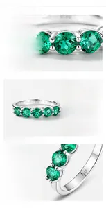 Macro view of lab-grown emerald row ring in S925 sterling silver with engraved hallmark