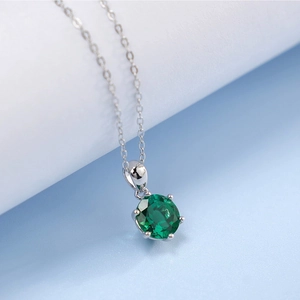 Macro shot of green lab-grown gemstone necklace with S925 silver six-prong setting