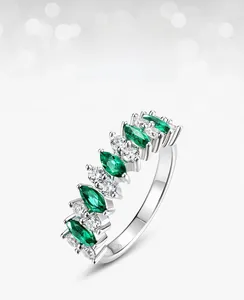 Macro detail of S925 silver ring featuring marquise emerald and white cubic zirconia