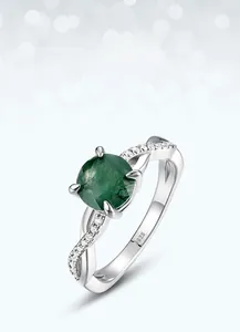 Detail of S925 silver ring with round moss agate stone and twisted pavé diamond band