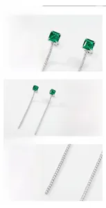 Vue macro des boucles d'oreilles à franges en argent S925 avec émeraudes de synthèse