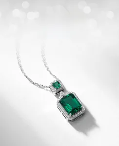 Detailed view of rectangular emerald pendant with pavé cubic zirconia in silver setting