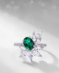 Macro view of lab-grown emerald ring with marquise zircon flower design in silver