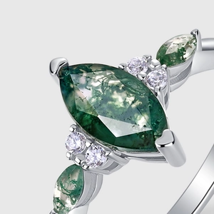 Marquise cut moss agate ring in S925 silver with side stones on light gray background