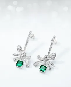 Detail of S925 hallmark on silver bow earrings with square emerald lab-grown gemstone