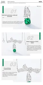 Detail of S925 silver bow necklace featuring cushion cut emerald with polished finish