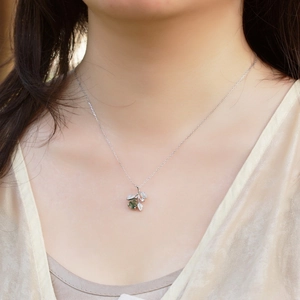 S925 silver necklace with teardrop green moss agate pendant worn on a model's neck