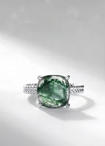 Macro view of square-cut moss agate ring with silver twisted double-rope band