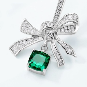 Elegant S925 silver bow earrings with emerald gemstone and sparkling white diamonds