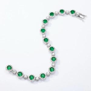 Luxurious S925 silver emerald bracelet with round halo settings and brilliant diamonds