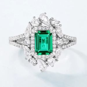Elegant S925 silver ring featuring emerald cut green gemstone with pear halo stones