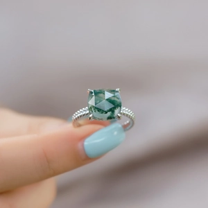 Square green moss agate ring with twisted rope silver band shown on hand close-up