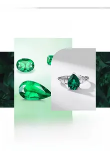 Macro detail of pear-cut emerald center stone with sparkling white zircon accents
