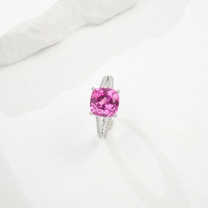 Macro shot of cushion cut pink gemstone ring with split shank and silver setting