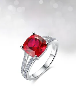 Macro shot of cushion-cut lab ruby ring with split shank and diamond accents